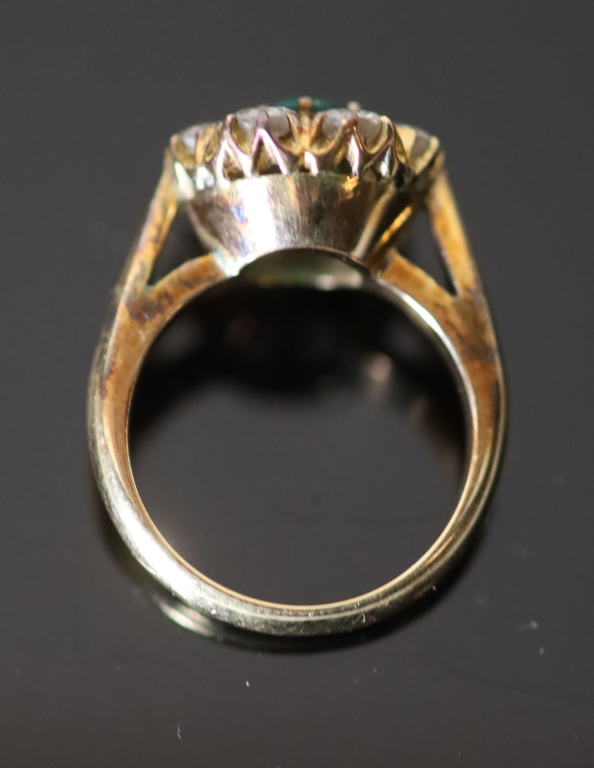 A 20th century gold, emerald and diamond set circular eight stone cluster ring,
